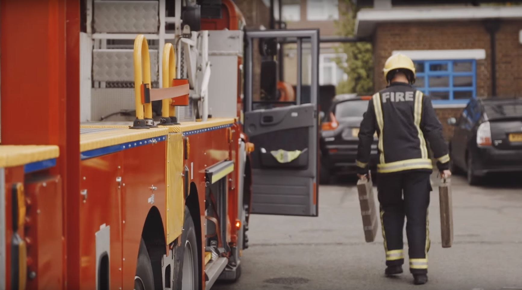 Firefighter alongside fire engine