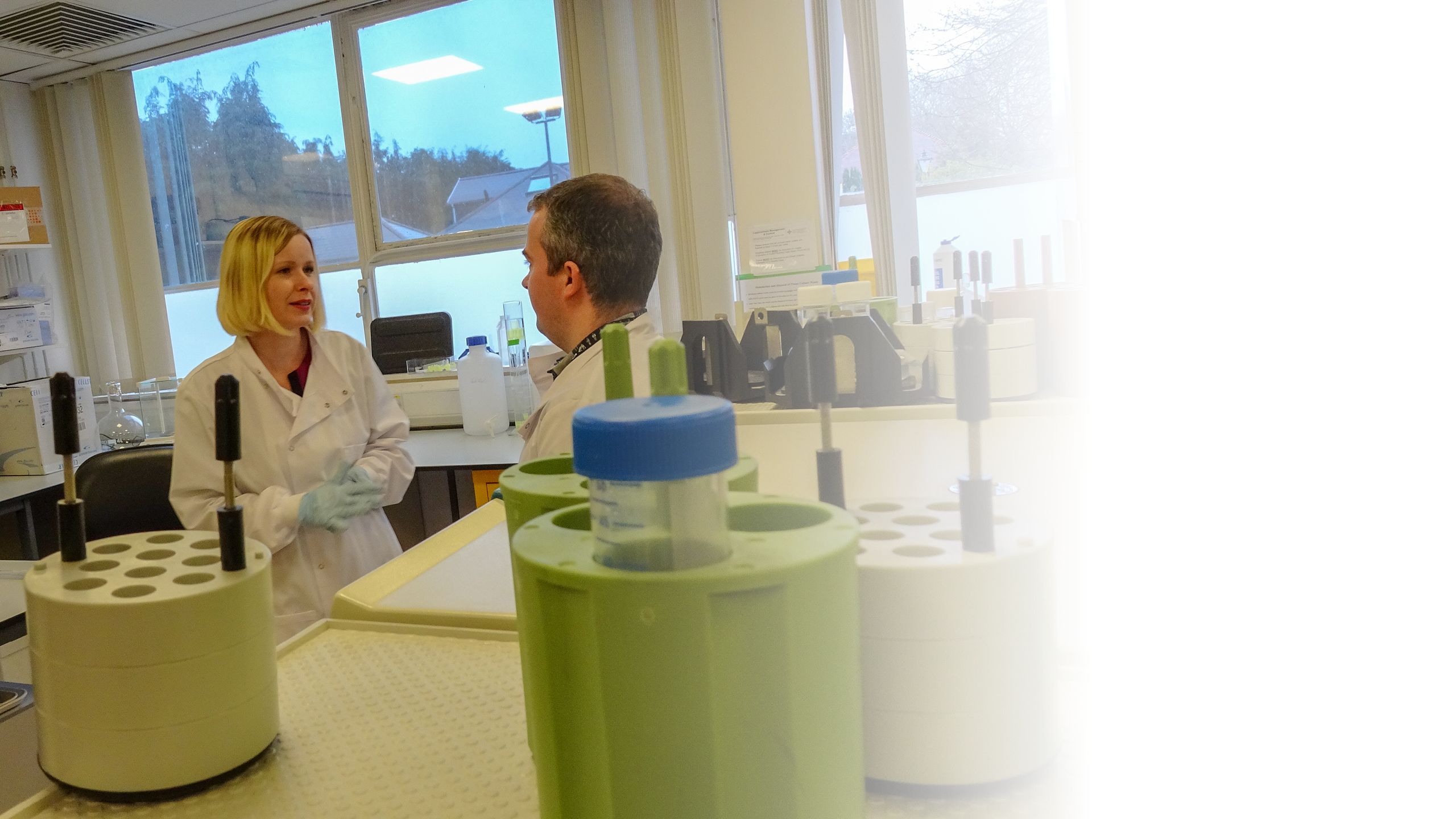 Magda in discussion with a colleague in the lab