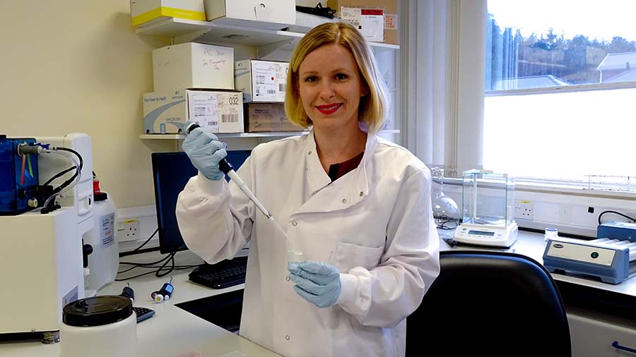 Magda in the lab in a white lab coat